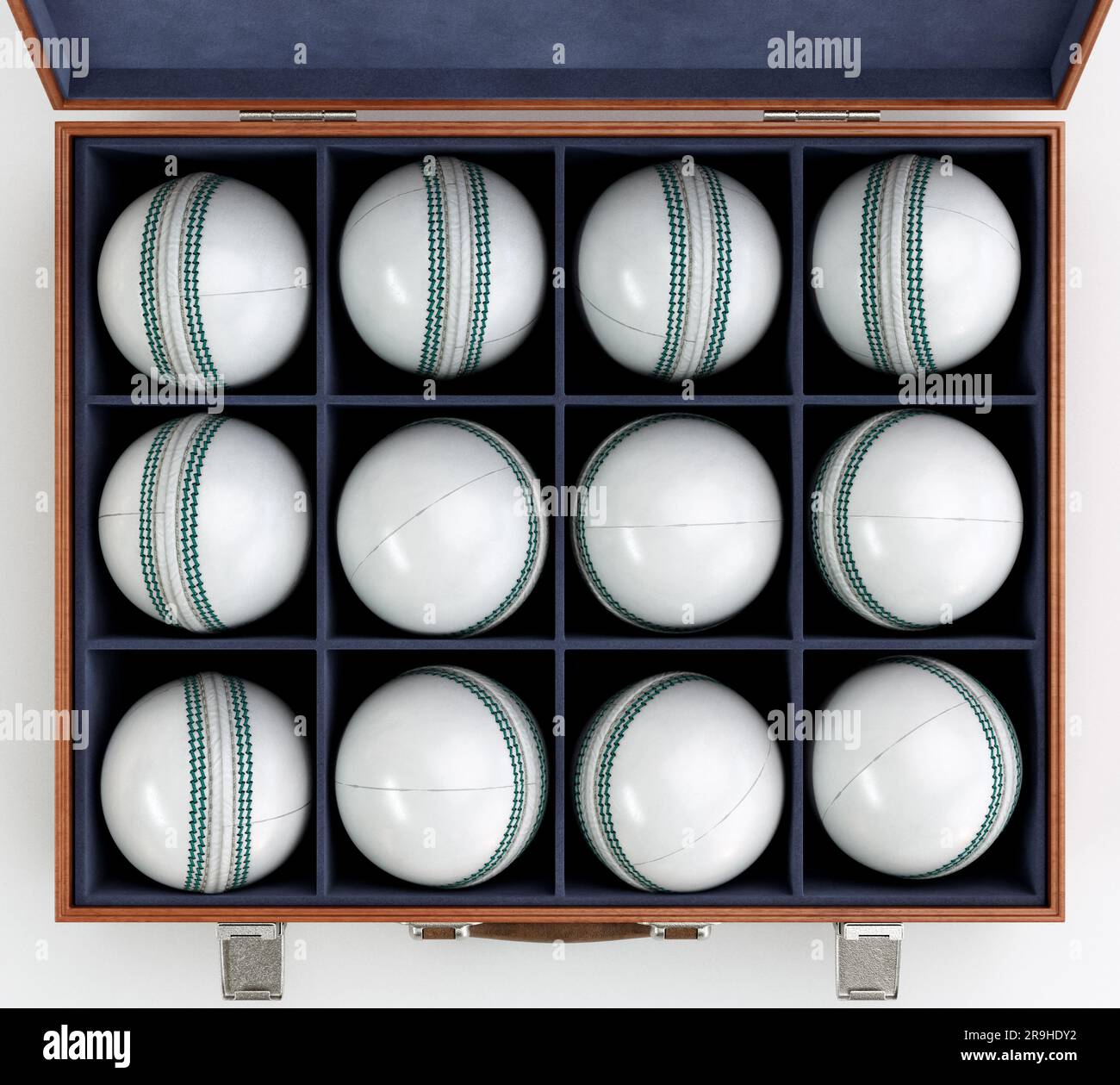 Twelve generic white cricket balls in a wooden display box lined with felt on an isolated white background - 3D render Stock Photo