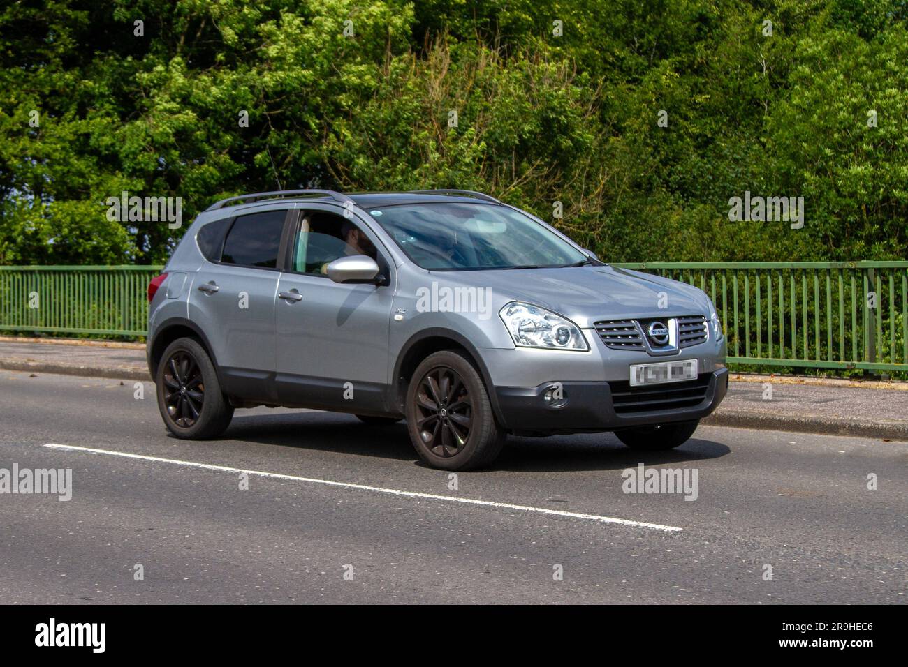 2009 Silver Nissan Qashqai N-Tec Dci 106 Car SUV Diesel 1461 cc; travelling at speed on the M6 motorway in Greater Manchester, UK Stock Photo