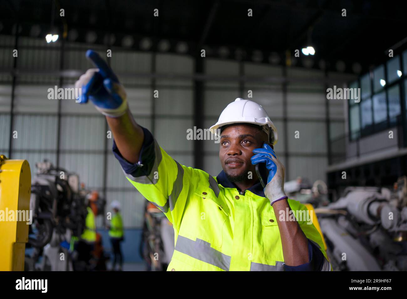 Engineer work at robotic arm factory. Technology and engineering concept. Stock Photo