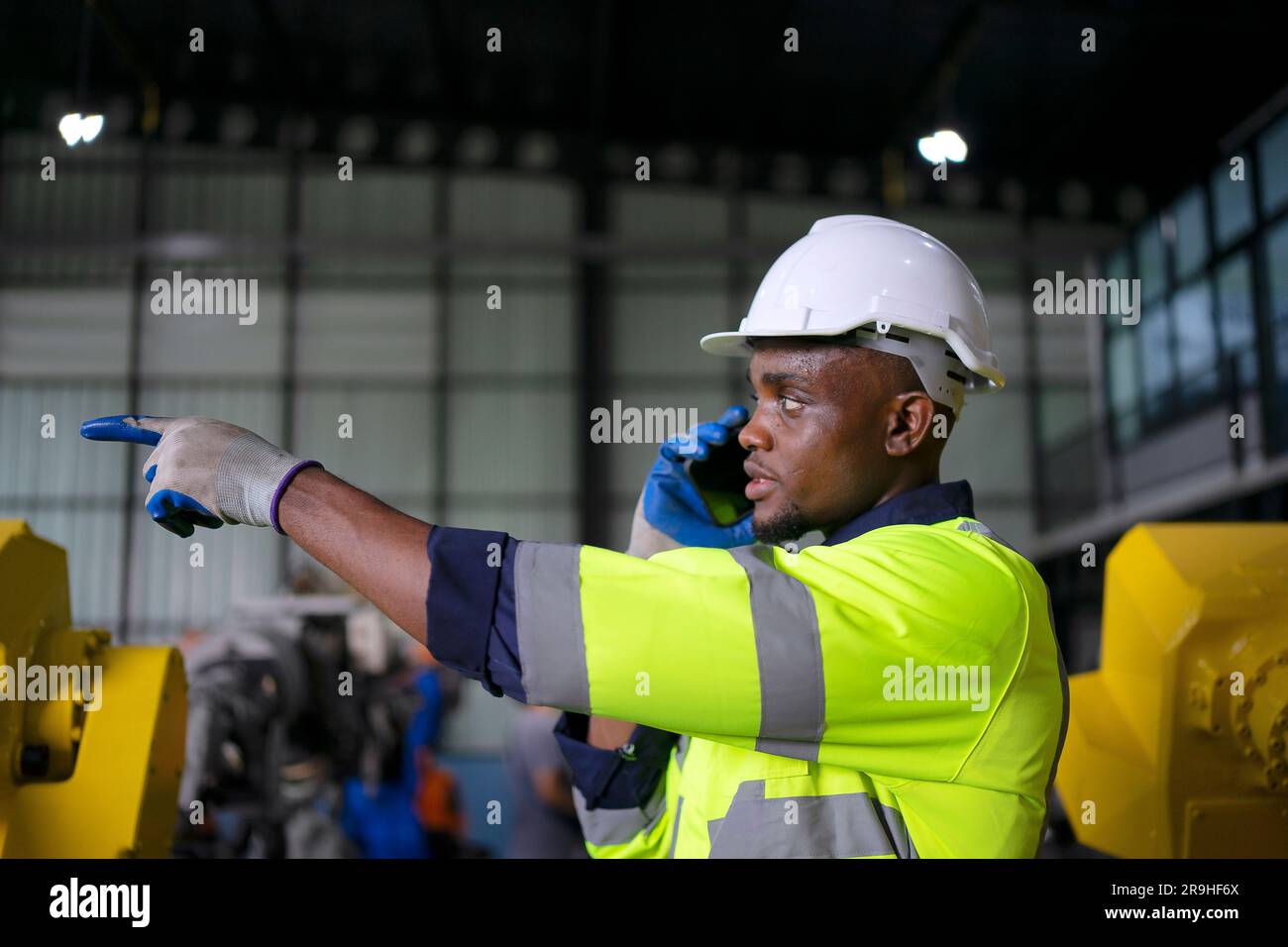 Engineer work at robotic arm factory. Technology and engineering concept. Stock Photo
