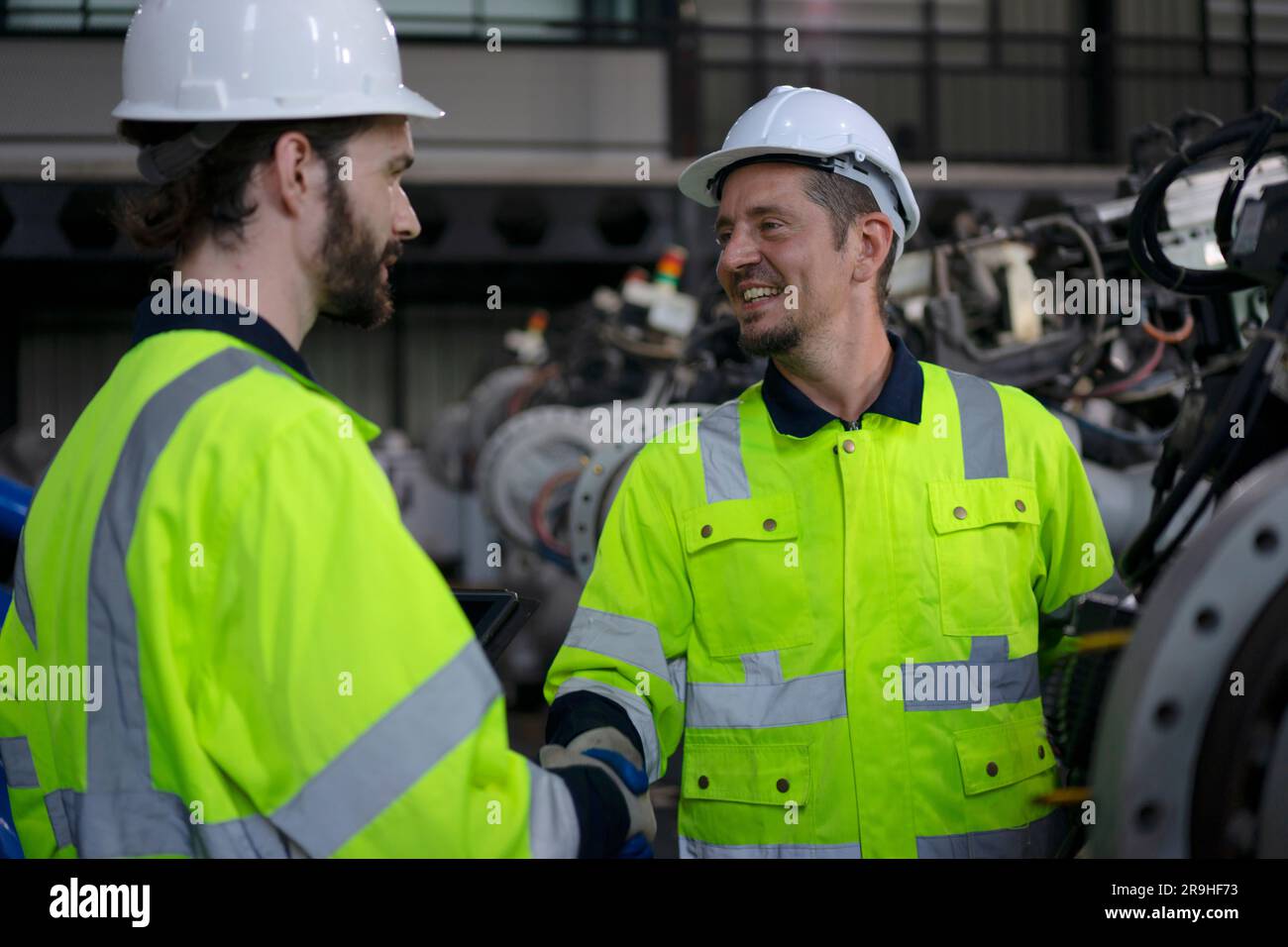Engineer work at robotic arm factory. Technology and engineering concept. Stock Photo