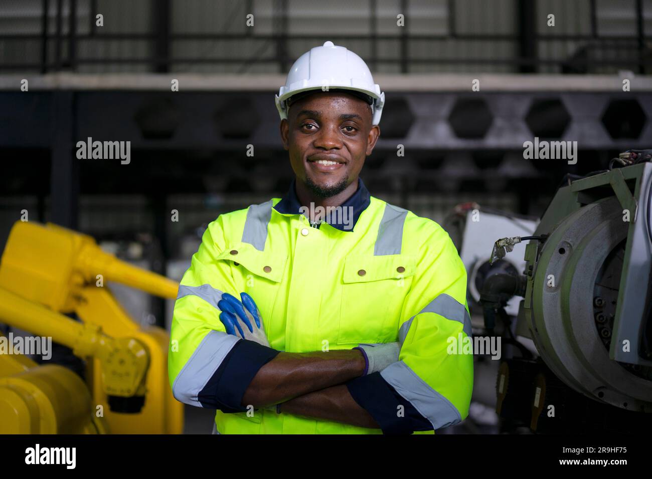Engineer work at robotic arm factory. Technology and engineering concept. Stock Photo