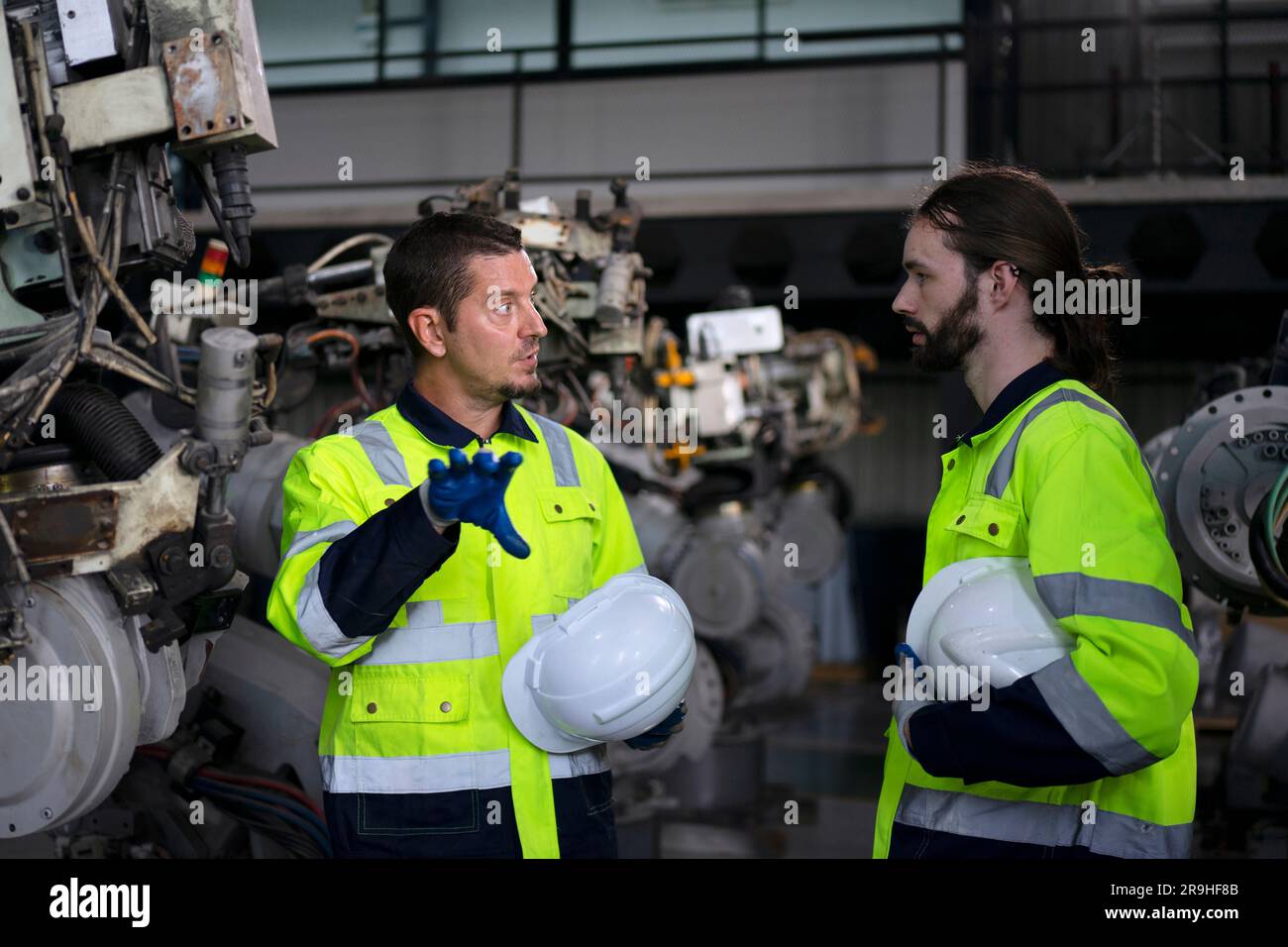 Engineer work at robotic arm factory. Technology and engineering concept. Stock Photo