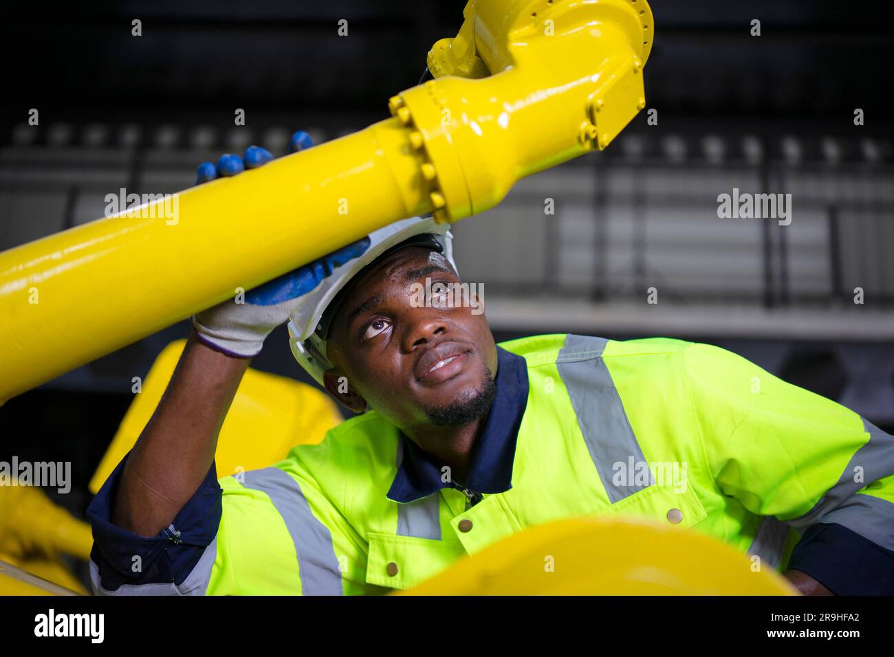 Engineer work at robotic arm factory. Technology and engineering concept. Stock Photo