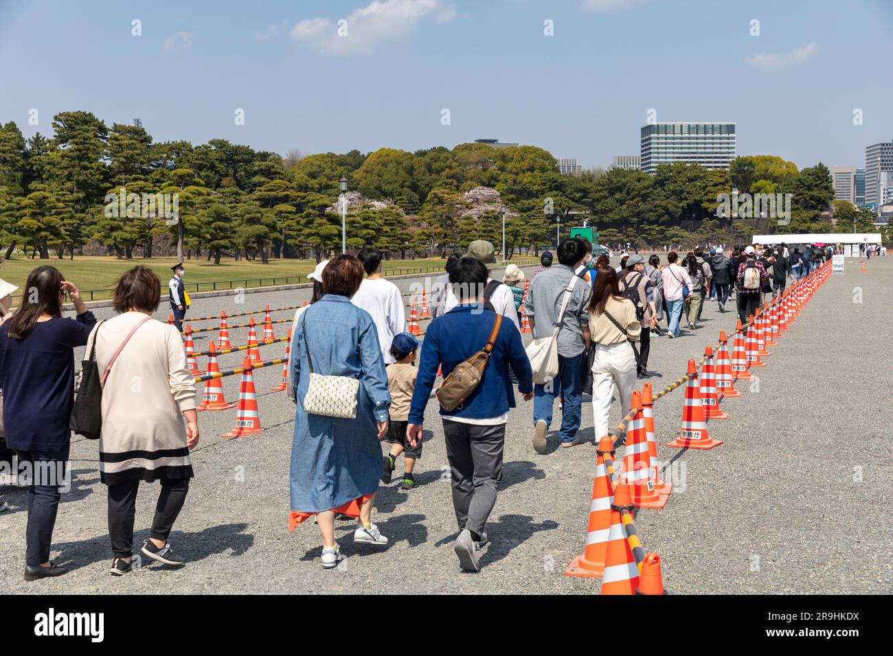 Tokyo Japan, 2023, people queue for security police check of bags to enter Imperial Palace gardens to view cherry blossom hanami,Japan,Asia Stock Photo