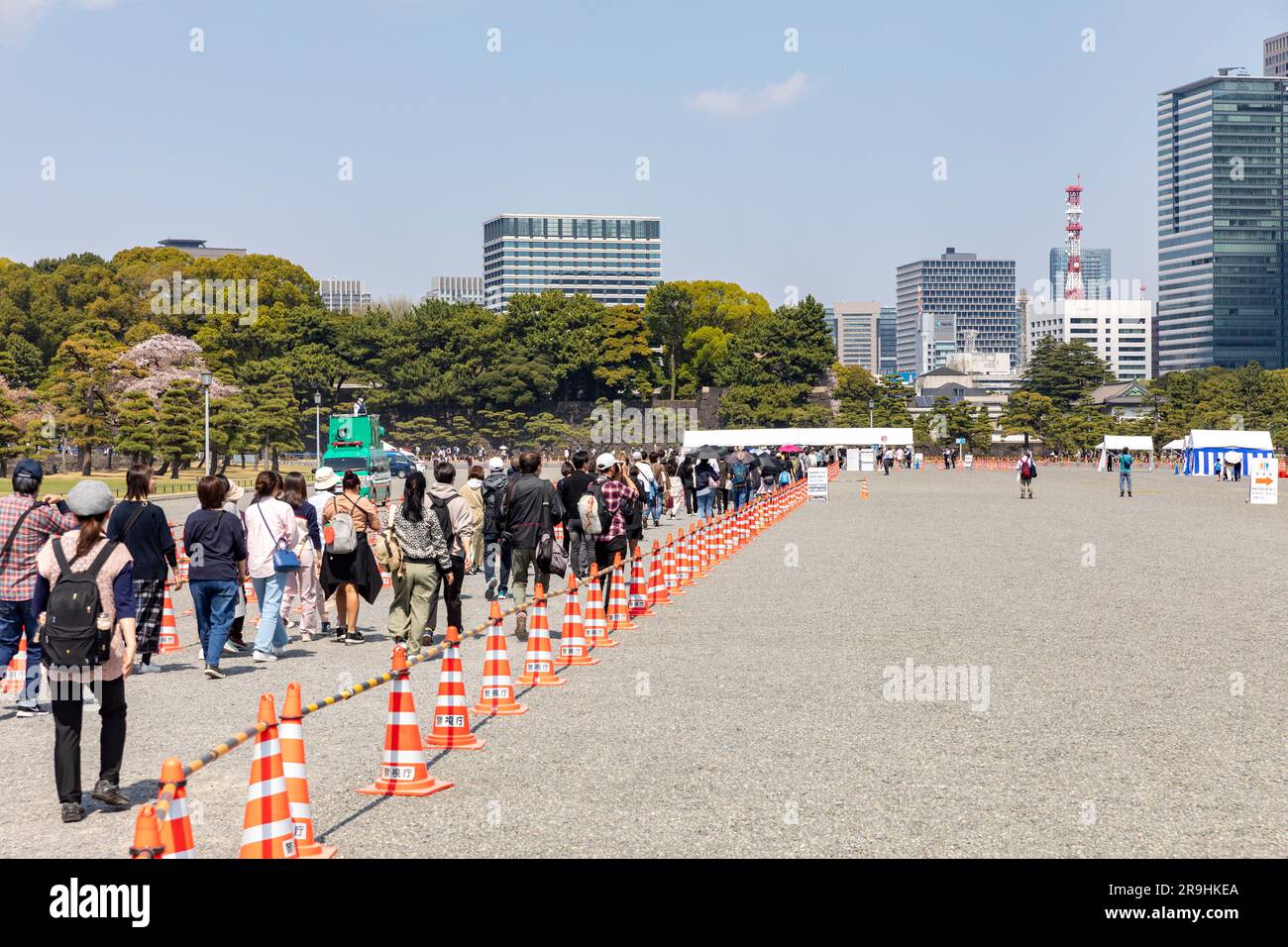 Tokyo Japan, 2023, people queue for security police check of bags to enter Imperial Palace gardens to view cherry blossom hanami,Japan,Asia Stock Photo