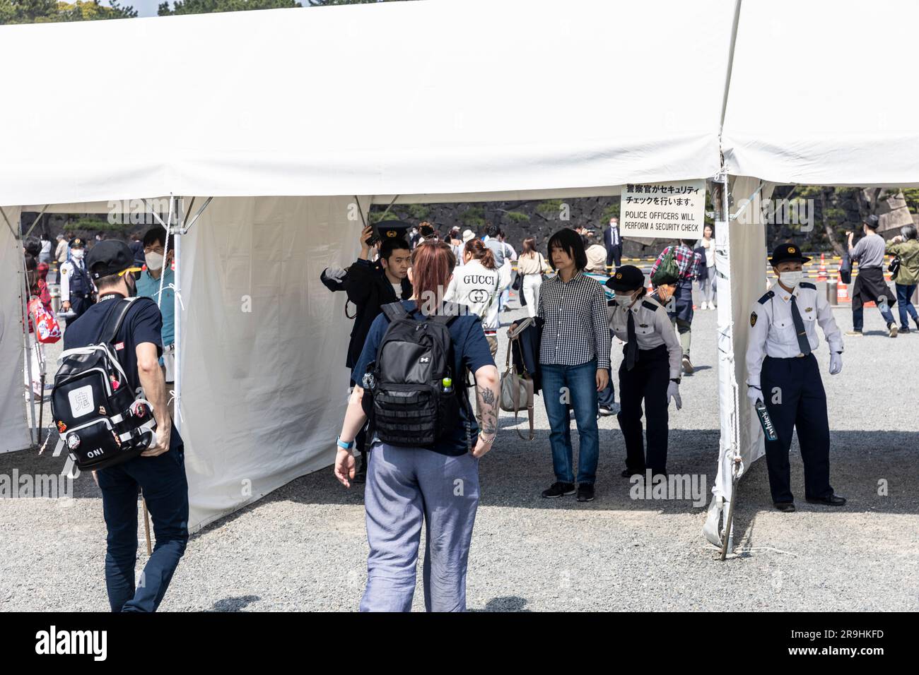 Tokyo Japan, closed during covid 19 visitors queue at police security checkpoint to enter