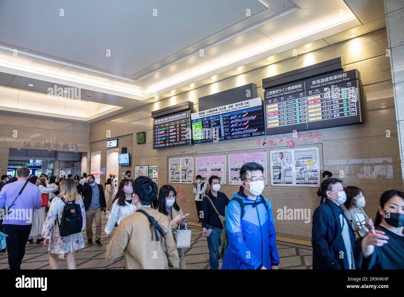 Tokyo central station, train commuters walk through tokyo train station past customer departure boards , Tokyo,Japan,Asia,2023 Stock Photo