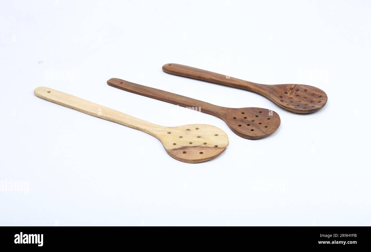 Three kitchen utensils against a white background - fish slice, potato  masher and wooden spoon Stock Photo - Alamy