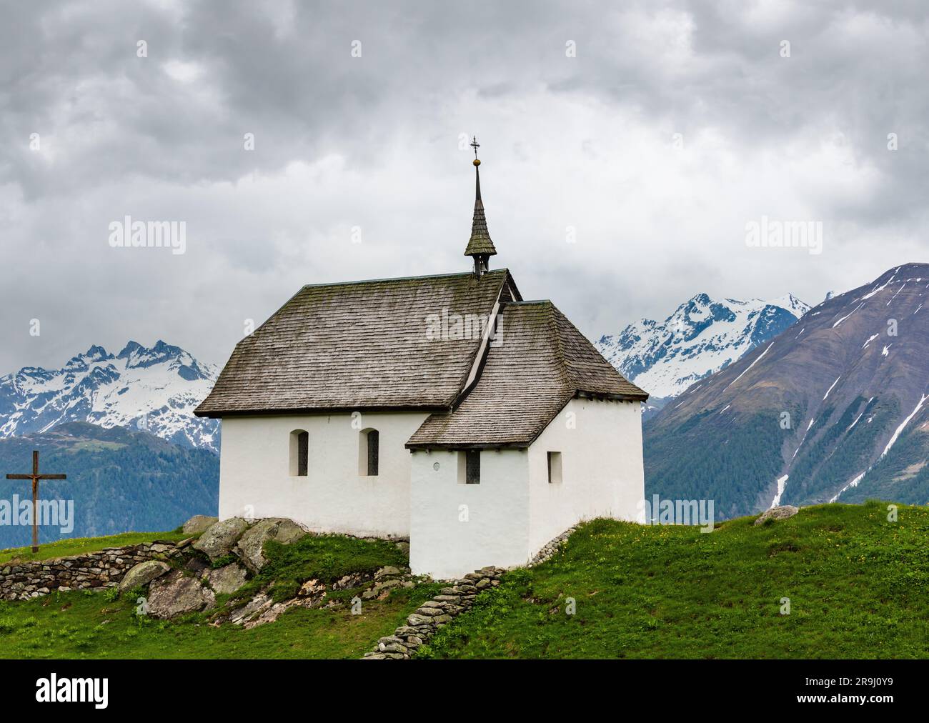 Lovely small old Church in Bettmeralp Alps mountain village, Switzerland. Summer cloudy view. Stock Photo