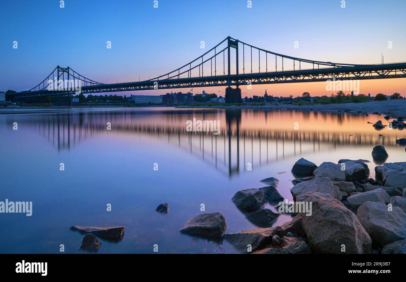 Old bridge crossing the Rhine river during sunset, Krefeld, North Rhine Westphalia, Germany Stock Photo