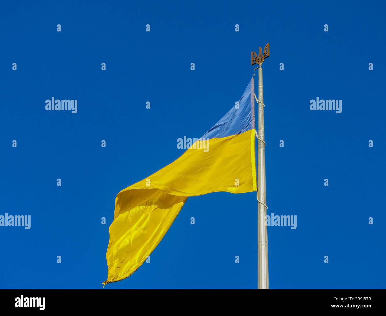 Ukraine flag large national symbol fluttering in blue sky. Large yellow blue Ukrainian state flag, Dnipro city, Independence Constitution Day, Nationa Stock Photo