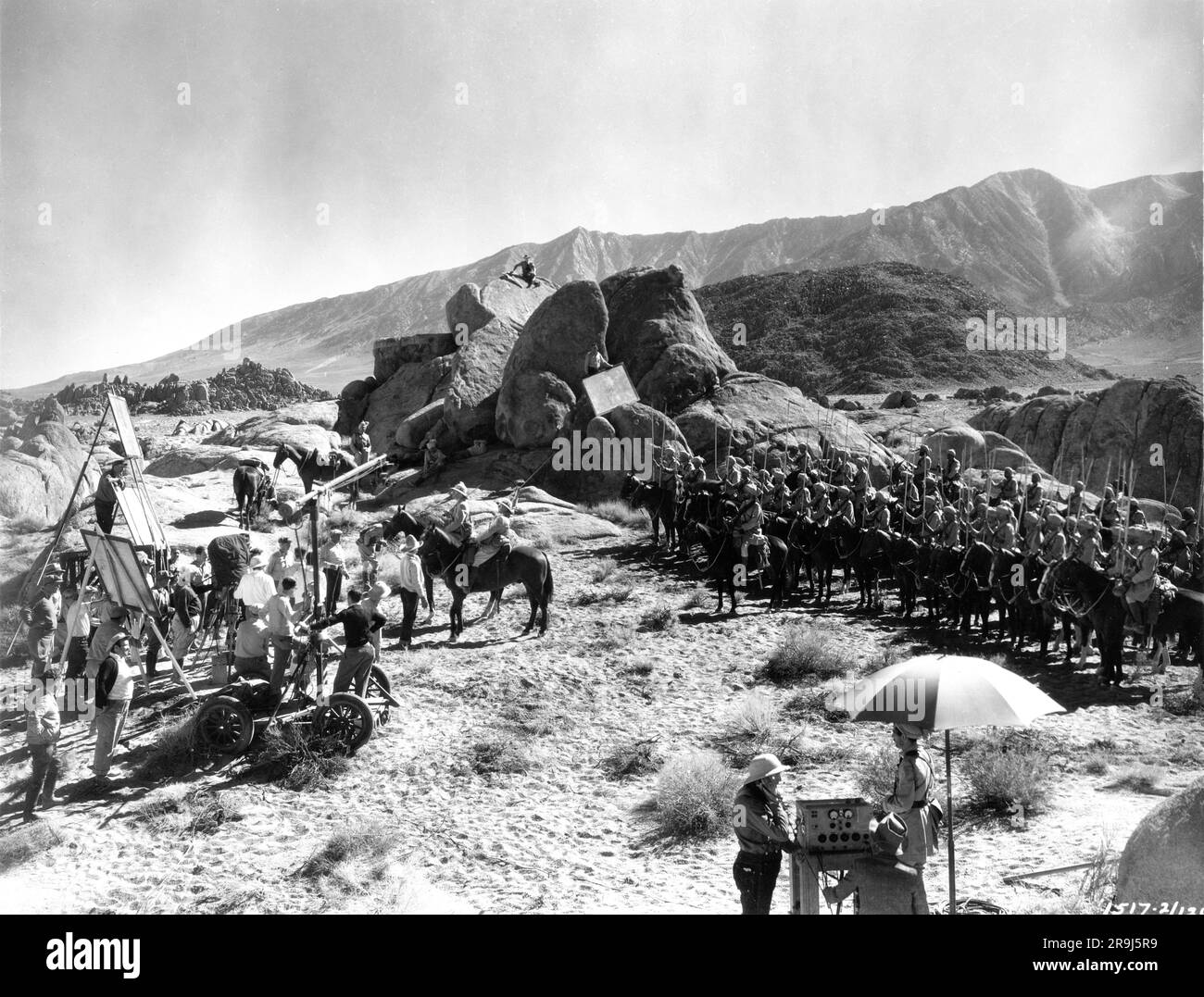 C. AUBREY SMITH and Sir GUY STANDING on set location candid with Movie Crew and Extras during filming of THE LIVES OF A BENGAL LANCER 1935 director HENRY HATHAWAY suggested by the novel by Francis Yeats Brown Paramount Pictures Stock Photo