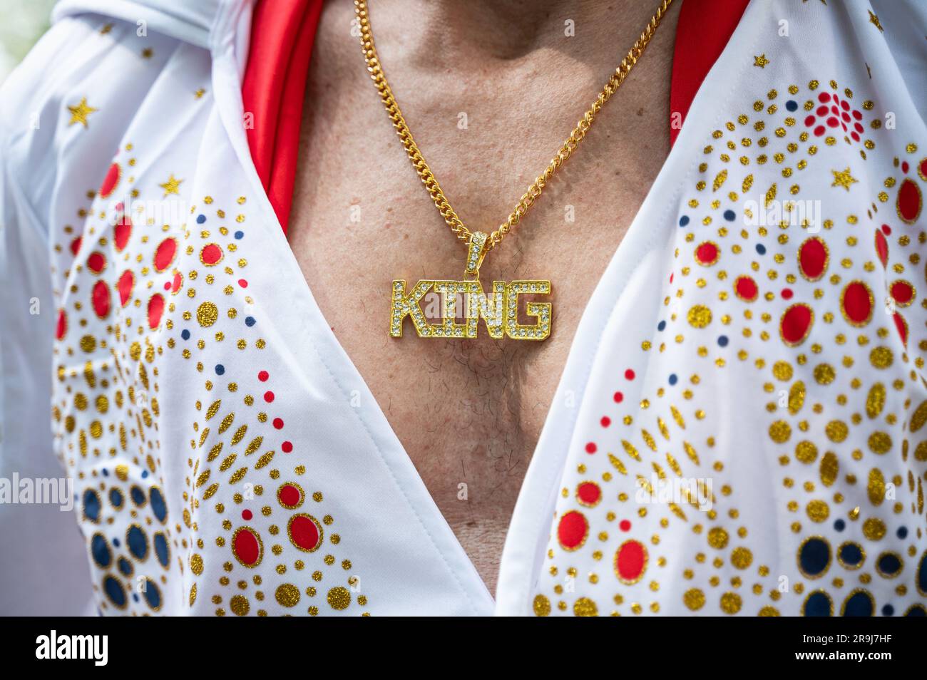 28.05.2023, Berlin, Germany, Europe - Close-up of the necklace with 'King" pendant of an Elvis impersonator at the Carnival of Cultures in Kreuzberg. Stock Photo