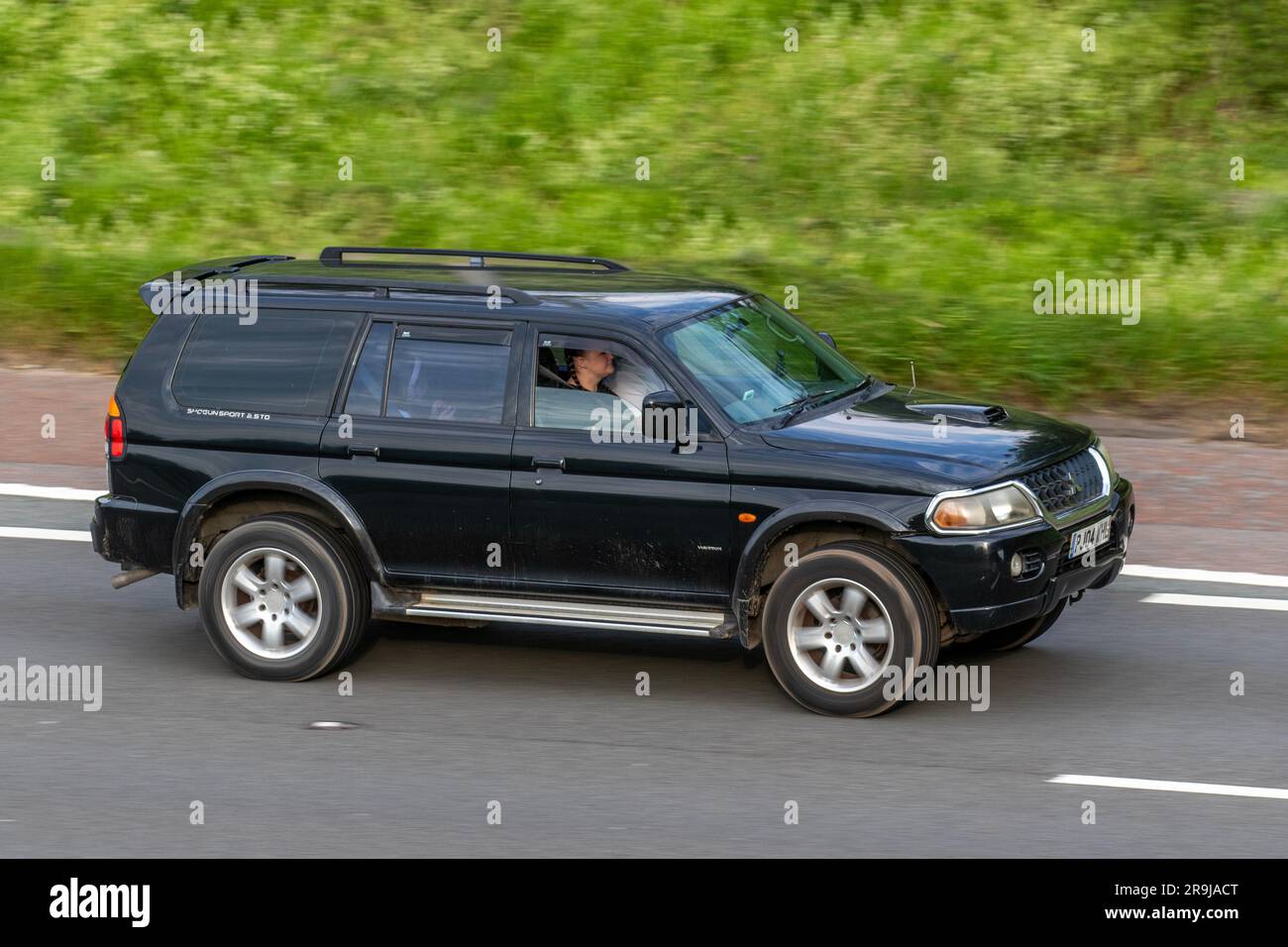 2004 Black Mitsubishi Shogun Sport Warrior DT TDT Car SUV Diesel 2477 cc; travelling at speed on the M6 motorway in Greater Manchester, UK Stock Photo