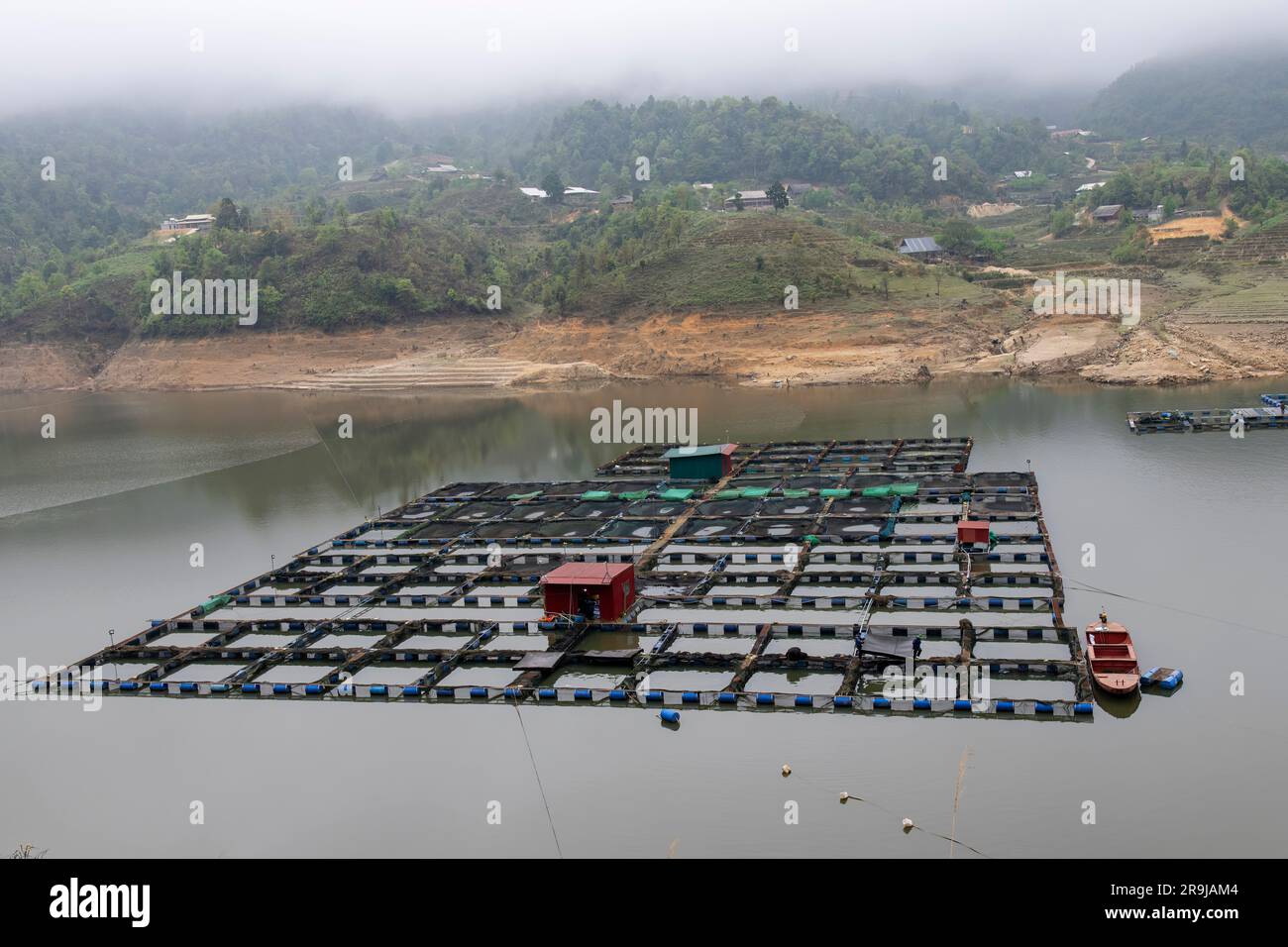 Ta Van, Sa Pa, Vietnam-April 2023; Net pens or cages for raising farmed fish, floating in the man-made Seo My Ty Sapa Lake Stock Photo
