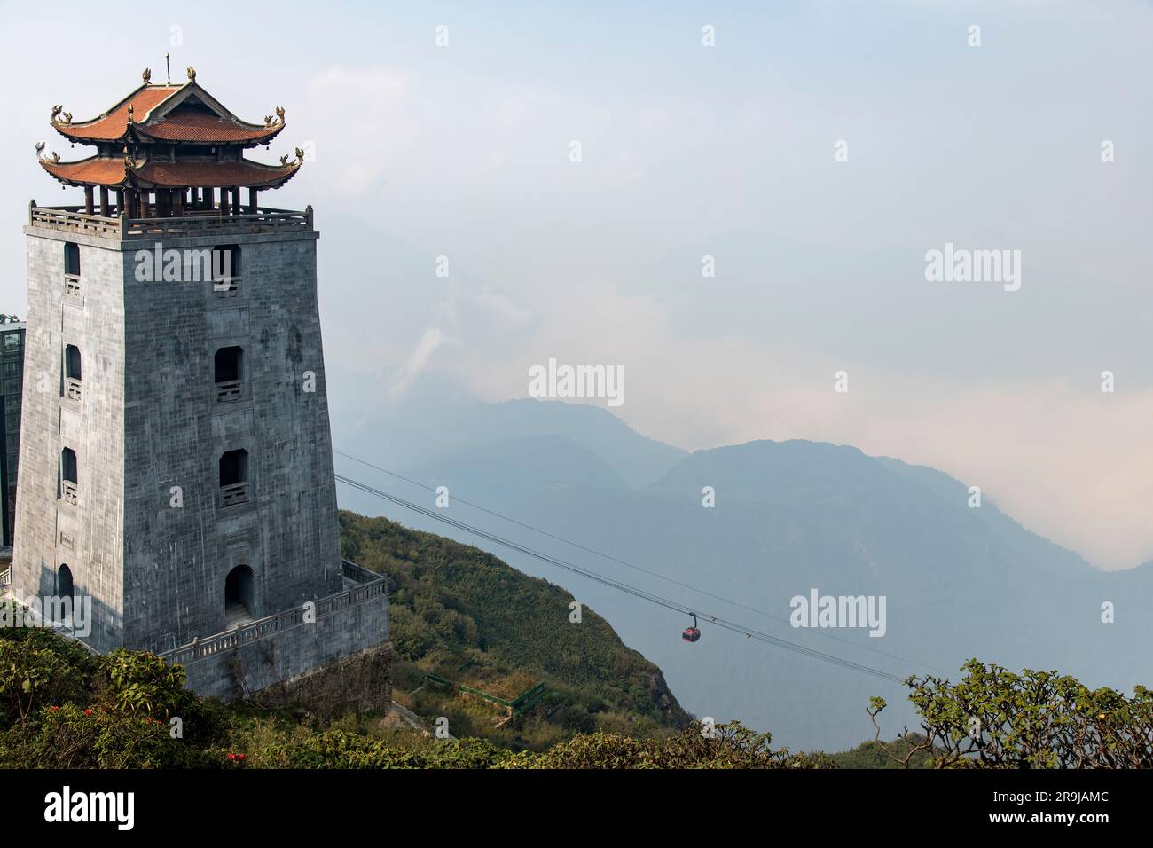 Sa Pa, Vietnam-April 2023; High angle view of Dai Hong Chung Watchtower on the top of Fanxipan Mountain with oncoming cable car Stock Photo