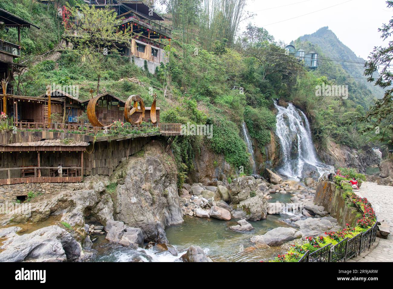 Cat Cat Village, Sapa, Vietnam-April 2023; River and waterfall in the traditional village of Cat Cat known for its Water wheels for power generation a Stock Photo
