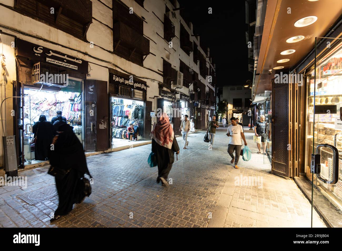 Jeddah, Saudi Arabia - January 26 2023: People walk at night in the streets of the Souq of Jeddah traditional old town of Al-Balad in Saudi Arabia Stock Photo