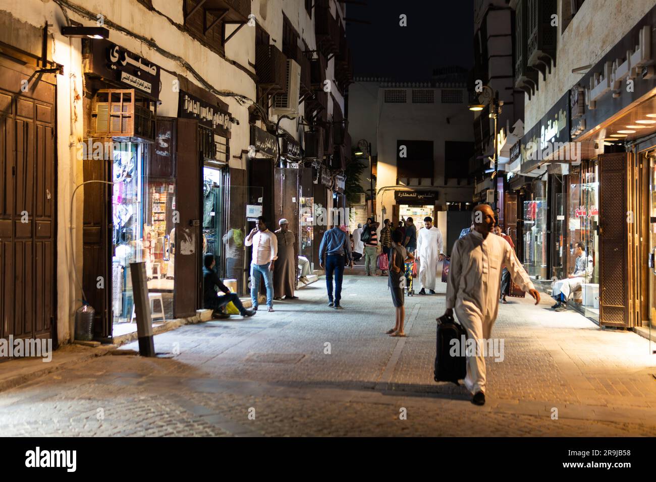 Jeddah, Saudi Arabia - January 26 2023: An Arab man walks at night in the streets of the Souq of Jeddah traditional old town of Al-Balad in Saudi Arab Stock Photo