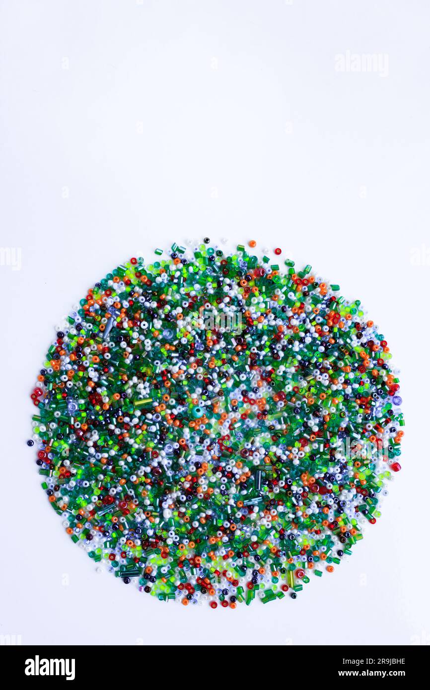 A circle of small colored beads on a white background. Stock Photo