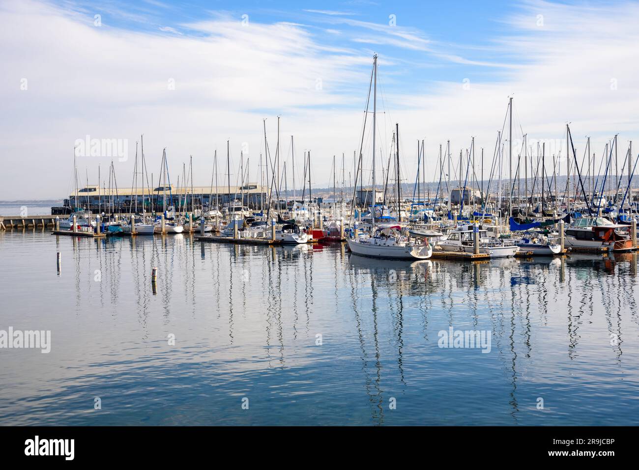 Sailing boats in a marina on a partly cloudy autumn morning Stock Photo