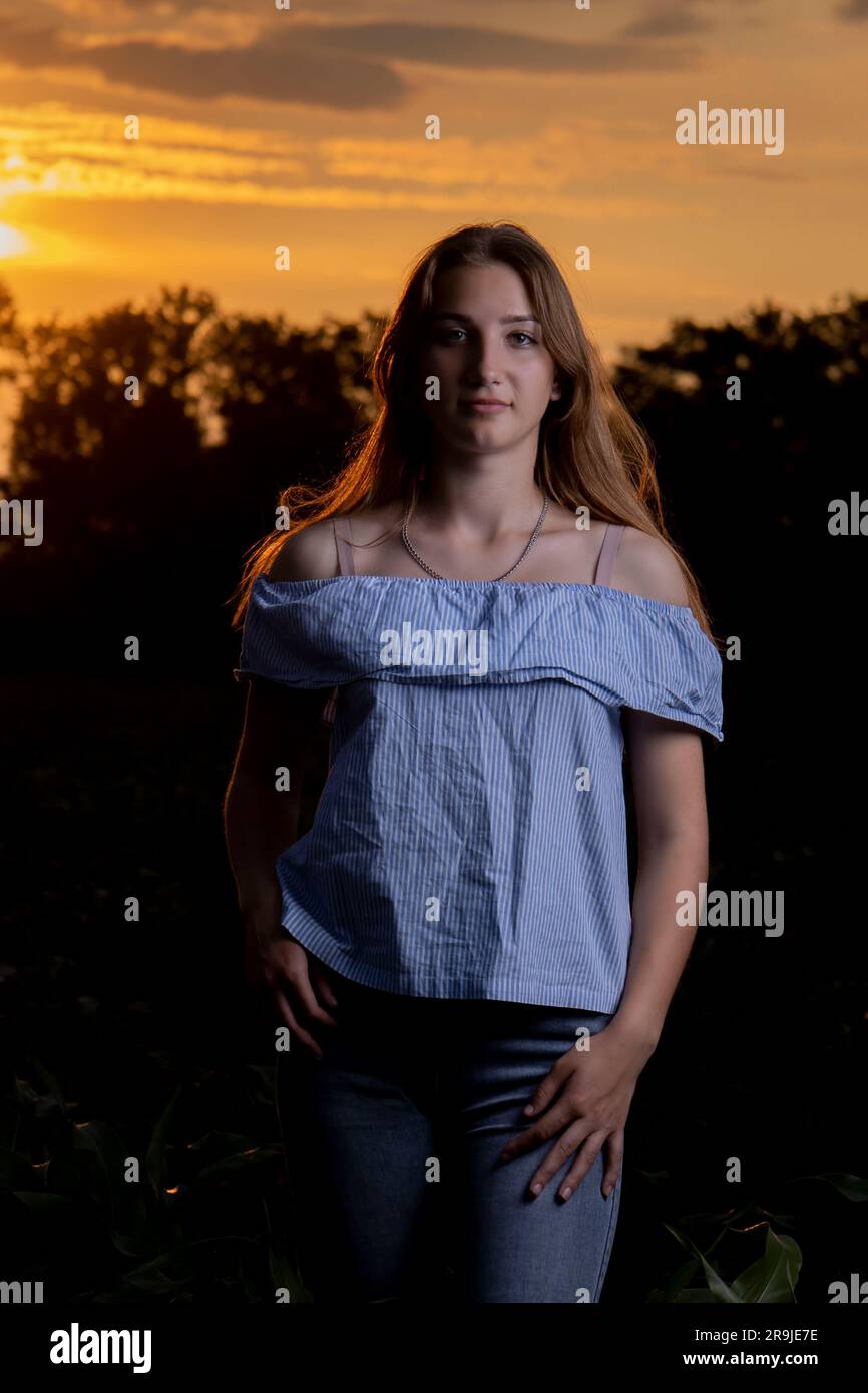 A young girl on the background of the sunset Stock Photo - Alamy