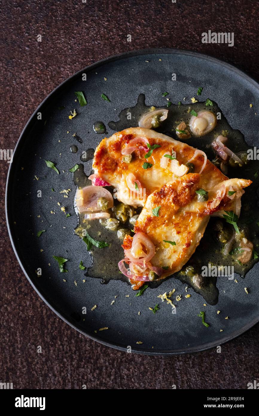 Chicken piccata with shallots and capers Stock Photo Alamy