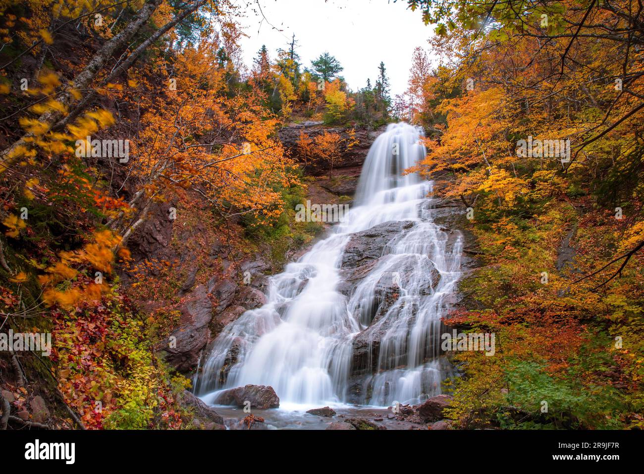 Beulach Ban Falls, Cape Breton -High water fall in an autumn forest landscape with dense trees, Cape Breton. Autumn waterfalls. Nova Scotia, Canada Stock Photo