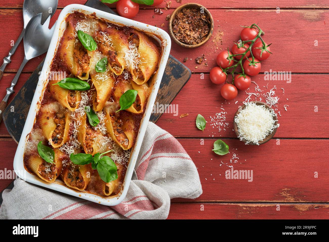 Cannelloni or conchiglioni. Baked stuffed pasta shells with bolognese