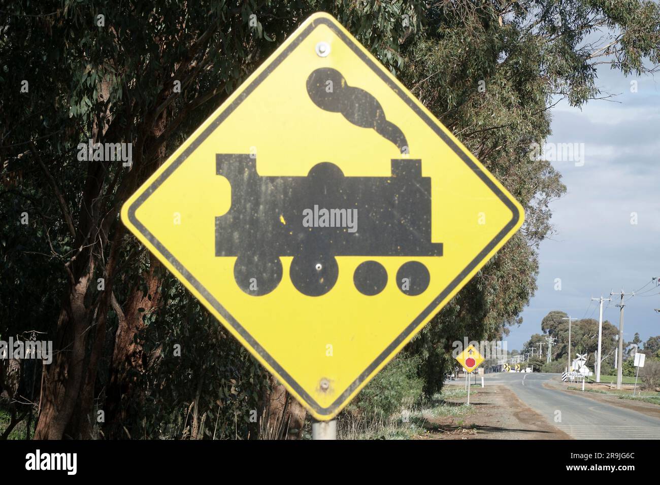 The Black Silhouette of a Steam Train Road Sign warning of a rail crossing ahead. Stock Photo