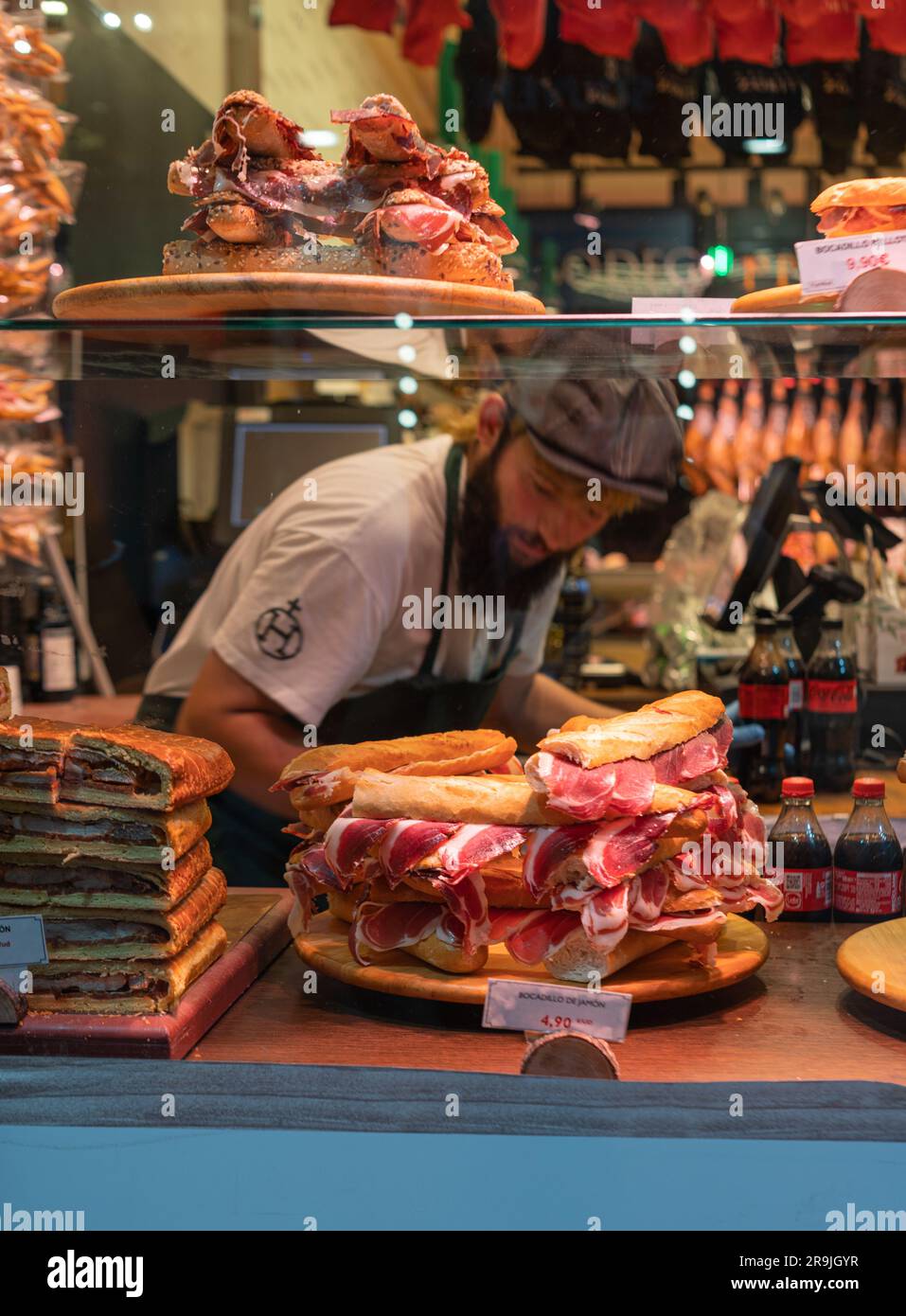 Spanish sandwiches with sliced jamon, bocadillo in cafe showcase Stock