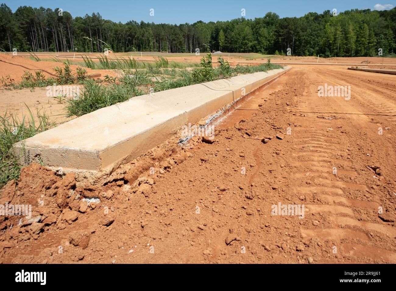 Concrete curbs in new residential subdivision have been poured on red