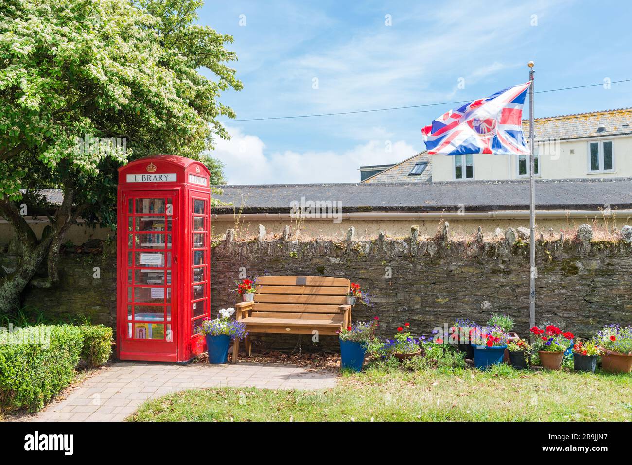 Old phone box book exchange and library in the South Hams village of Thurlestone, Devon Stock Photo