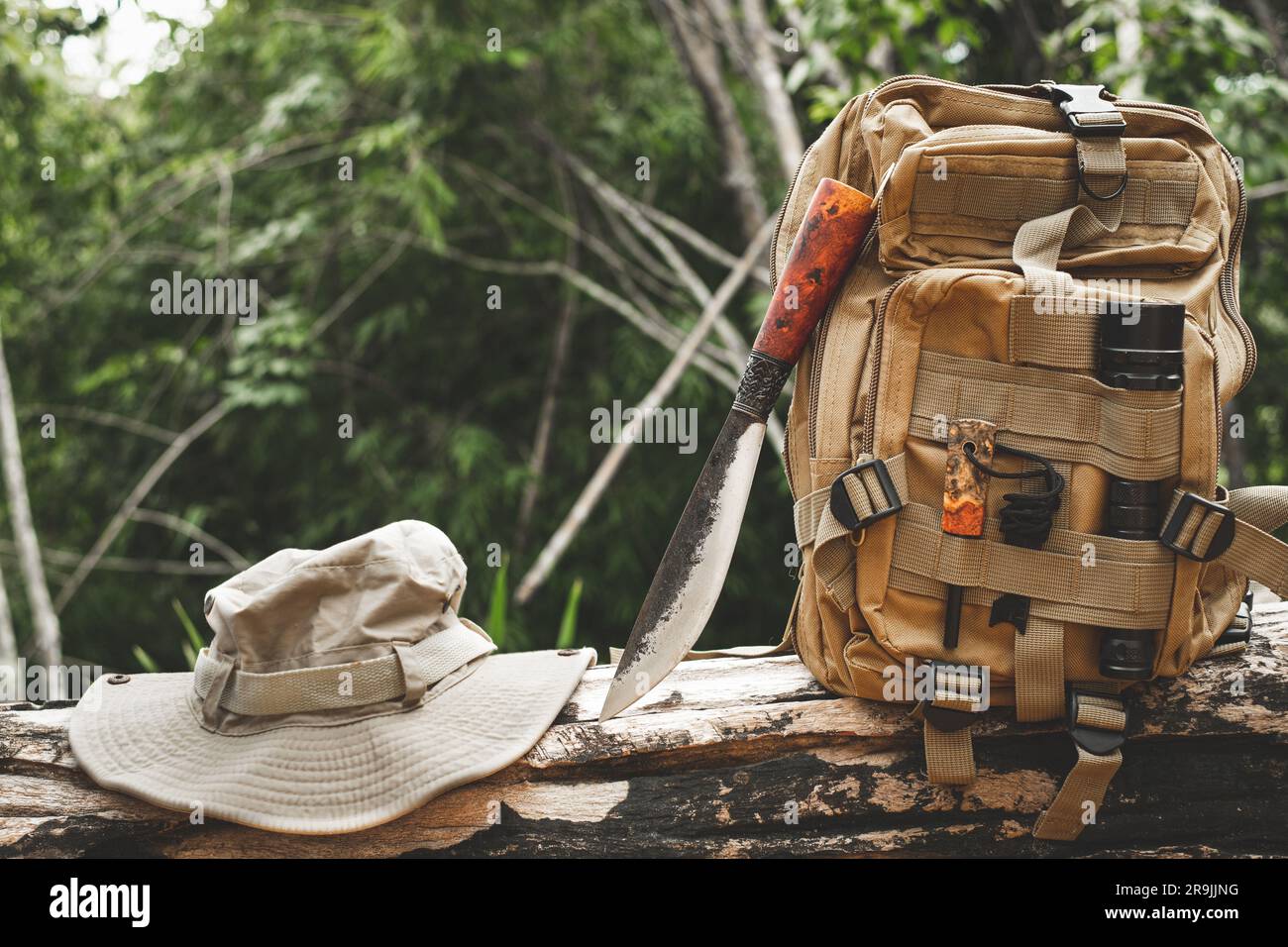 A knife backpack with equipment for survival in the forest on an old ...