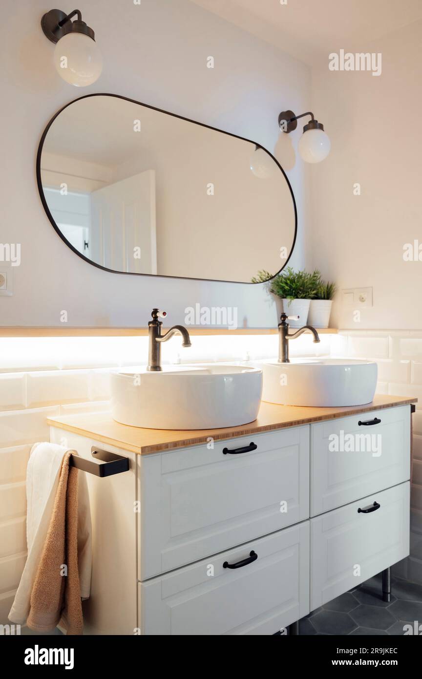 Interior design of bathroom with white ceramic sinks taps on wooden