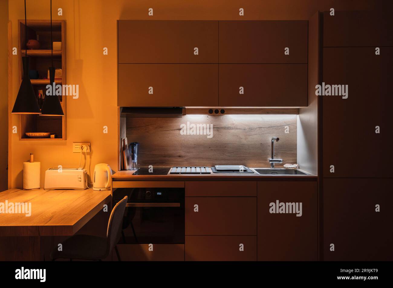 Interior design of minimalist kitchen integrated with dining area with