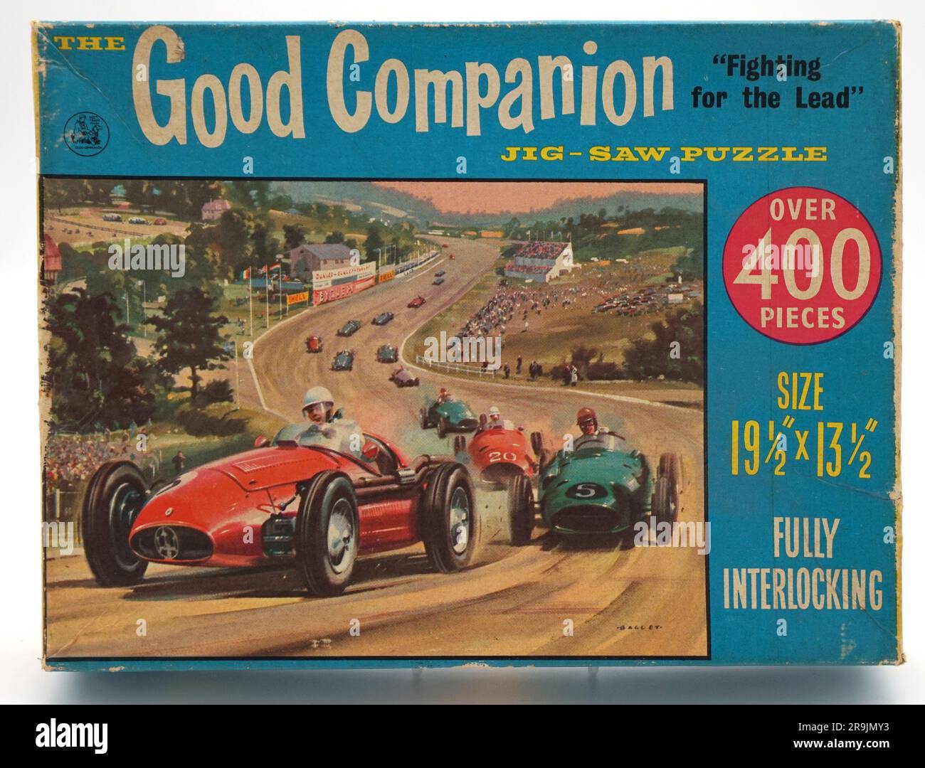 Vintage jigsaw box lid, showing dramatic car race from the 1950s. Bright illustration on the box lid, with bright graphics.  Good Companion range Stock Photo