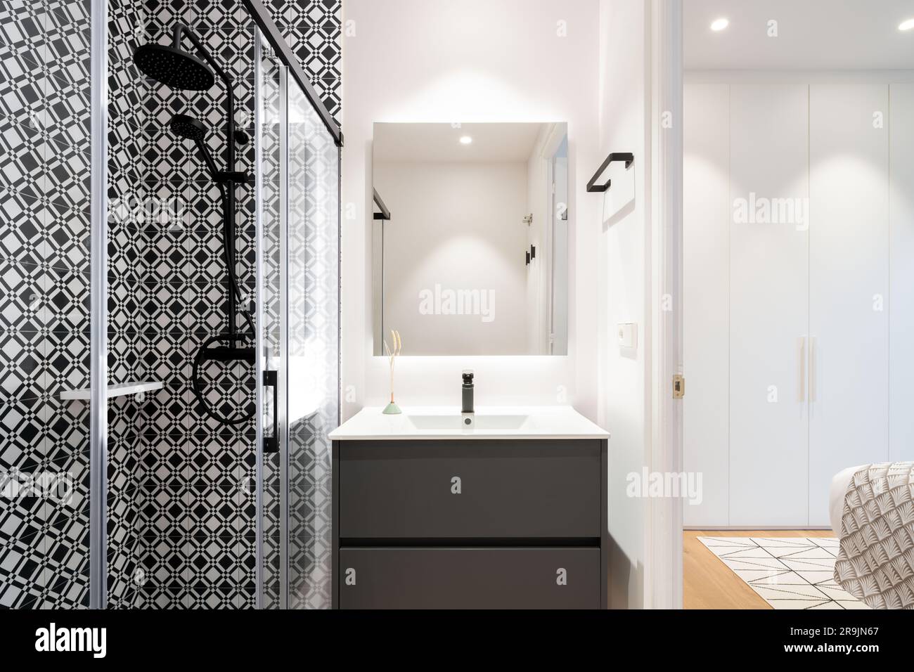 Interior of bathroom with glass shower cabin and white ceramic sink ...