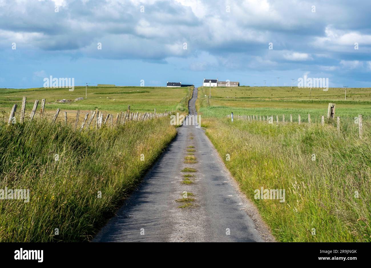 Long straight single track road from Balephuil to Balemartin, Isle of Tiree, Scotland. Stock Photo