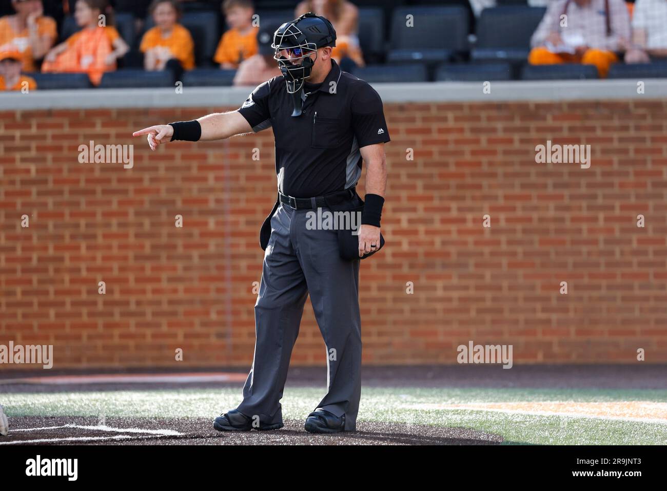 Home-plate umpire Jason Johnson signals to fellow crew members during the game between the Mississippi State Bulldogs and the Tennessee Volunteers on Robert M
