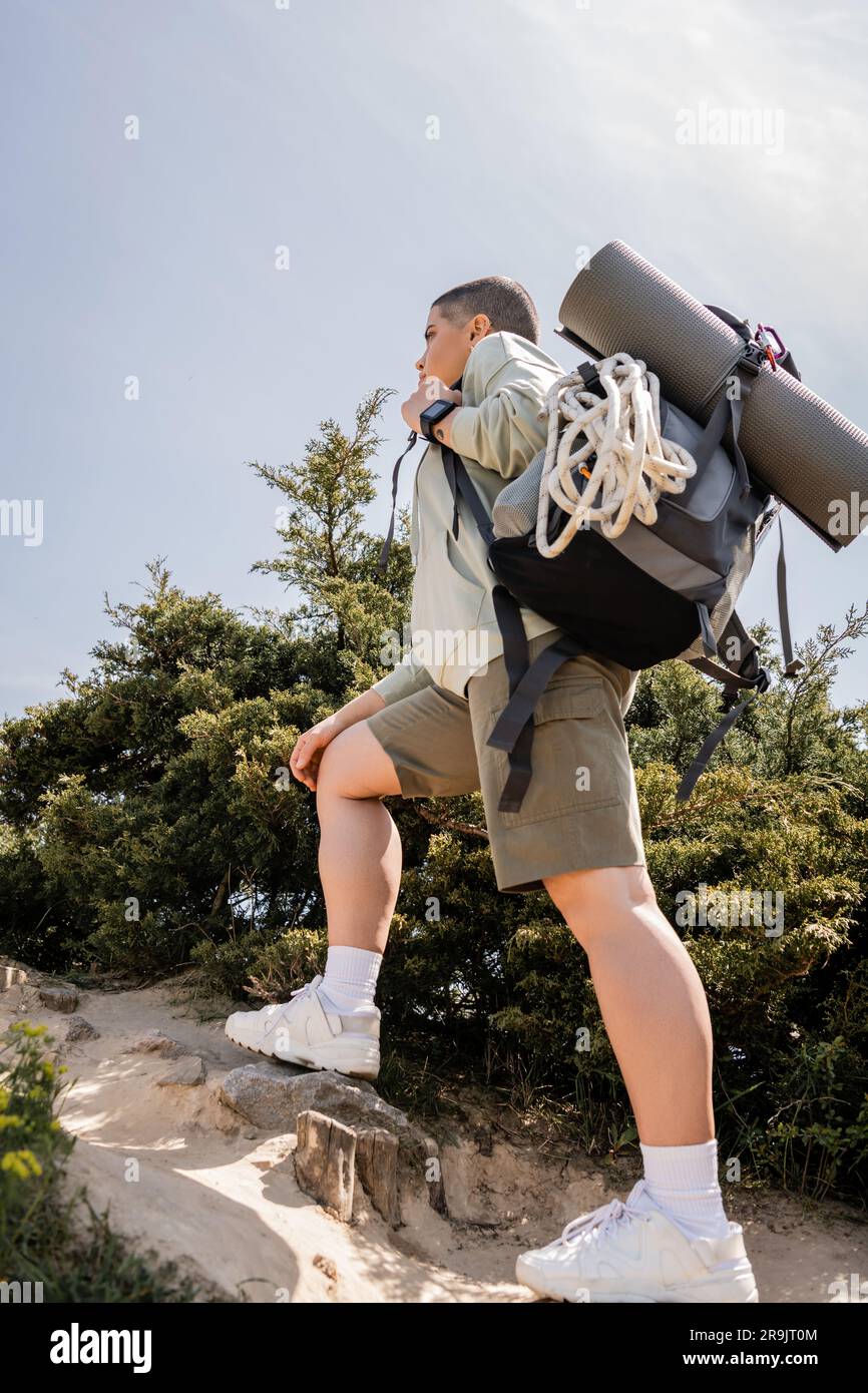 Young hiker climbing on hill hi-res stock photography and images - Alamy