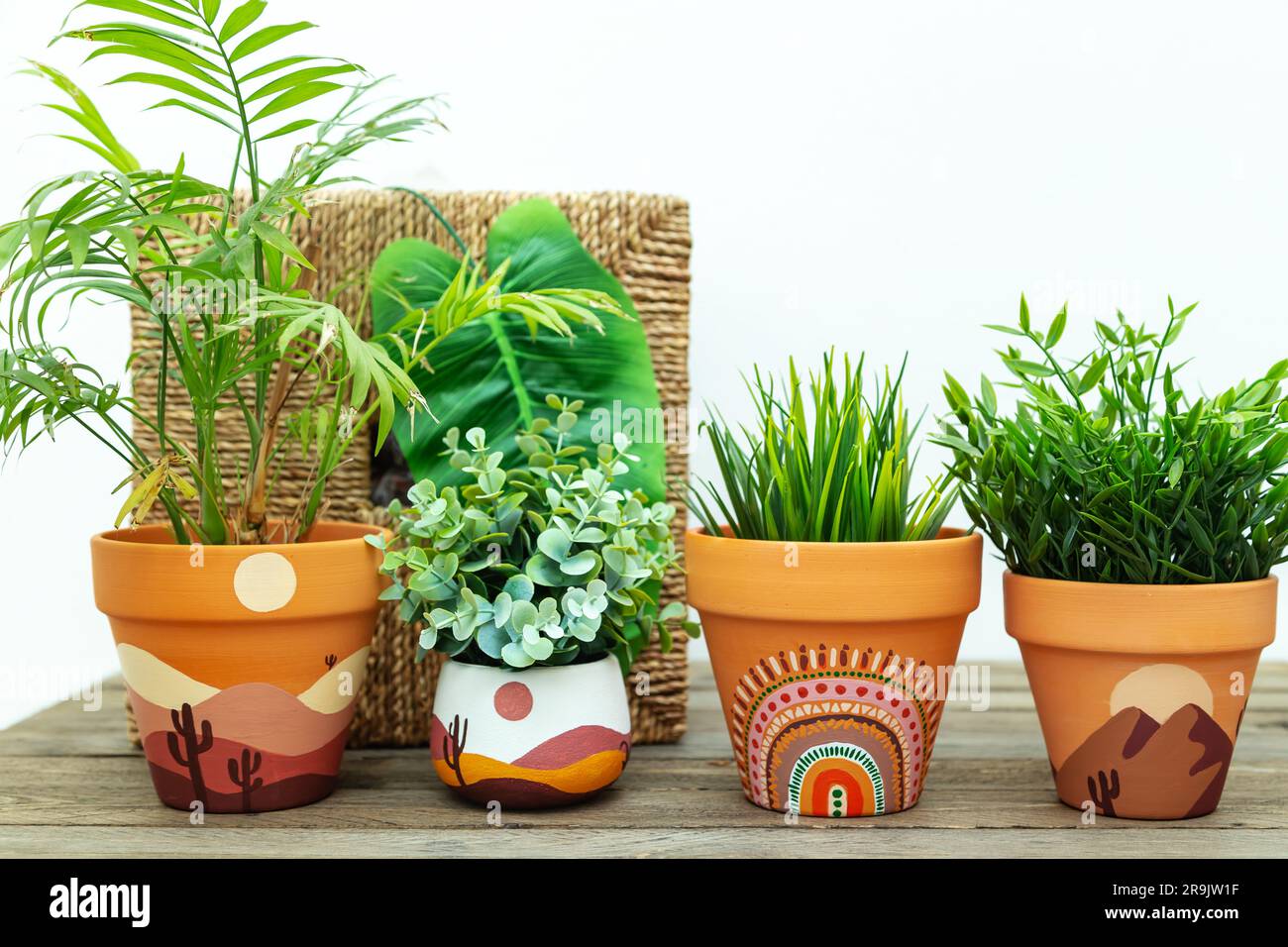 Artificial plants in clay terracotta pots. Hand painted with acrylics