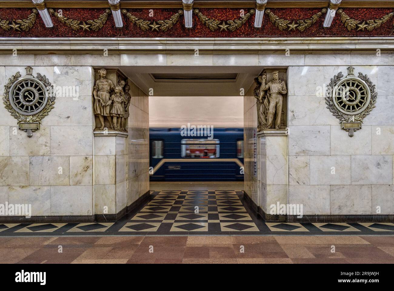 Narvskaya subway station in the city, built in the neoclassical style lined in white marble with many bronze inserts and a decorative frieze, a train Stock Photo
