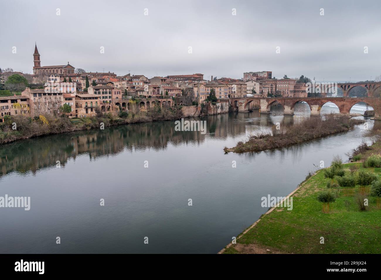 View of Albi, the city and historic buildings from the River Tarn, the Pont Vieux and an island in the stream. Stock Photo