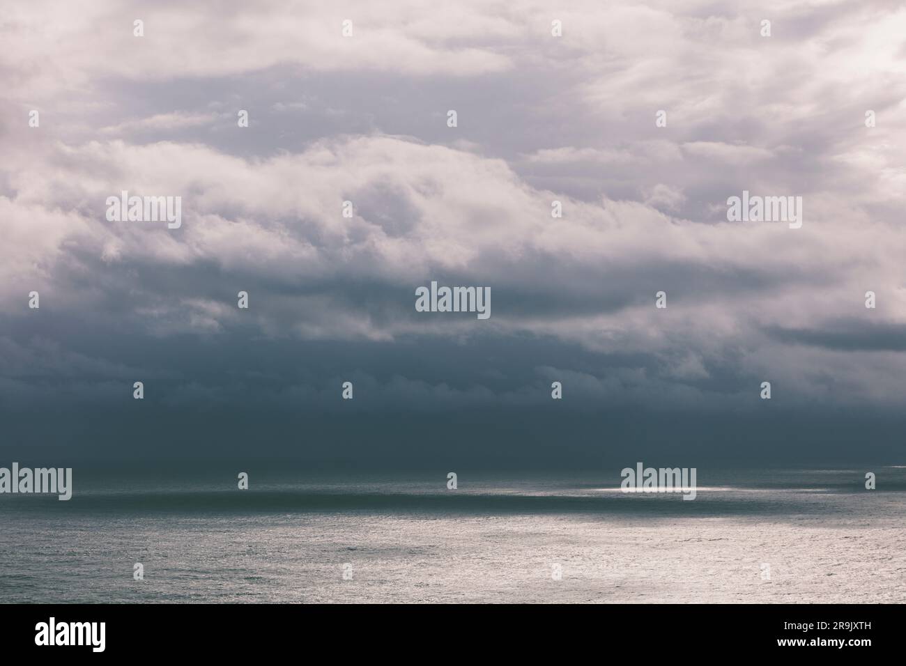 Storm clouds over the Pacific ocean at dusk Stock Photo