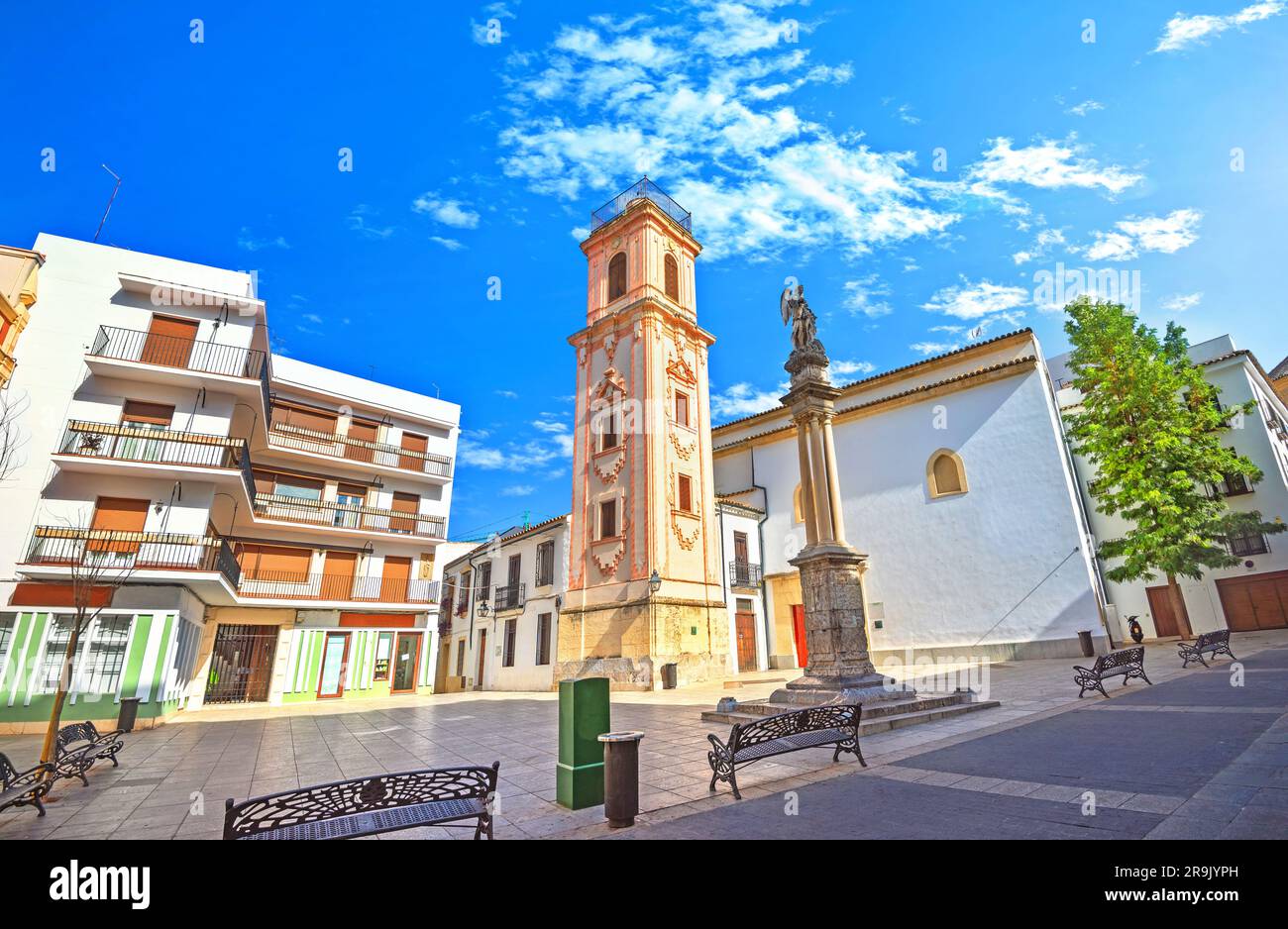 Cityscape with bell tower and monument on Plaza de la Compania square ...