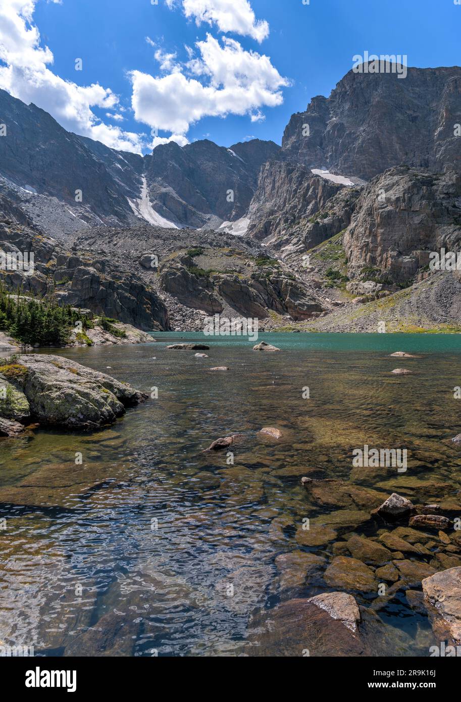 Sky Pond - A closeup view of a clear and colorful alpine lake - Sky Pond at base of Taylor Peak and Taylor Glacier on a sunny Summer day. RMNP, CO, US. Stock Photo