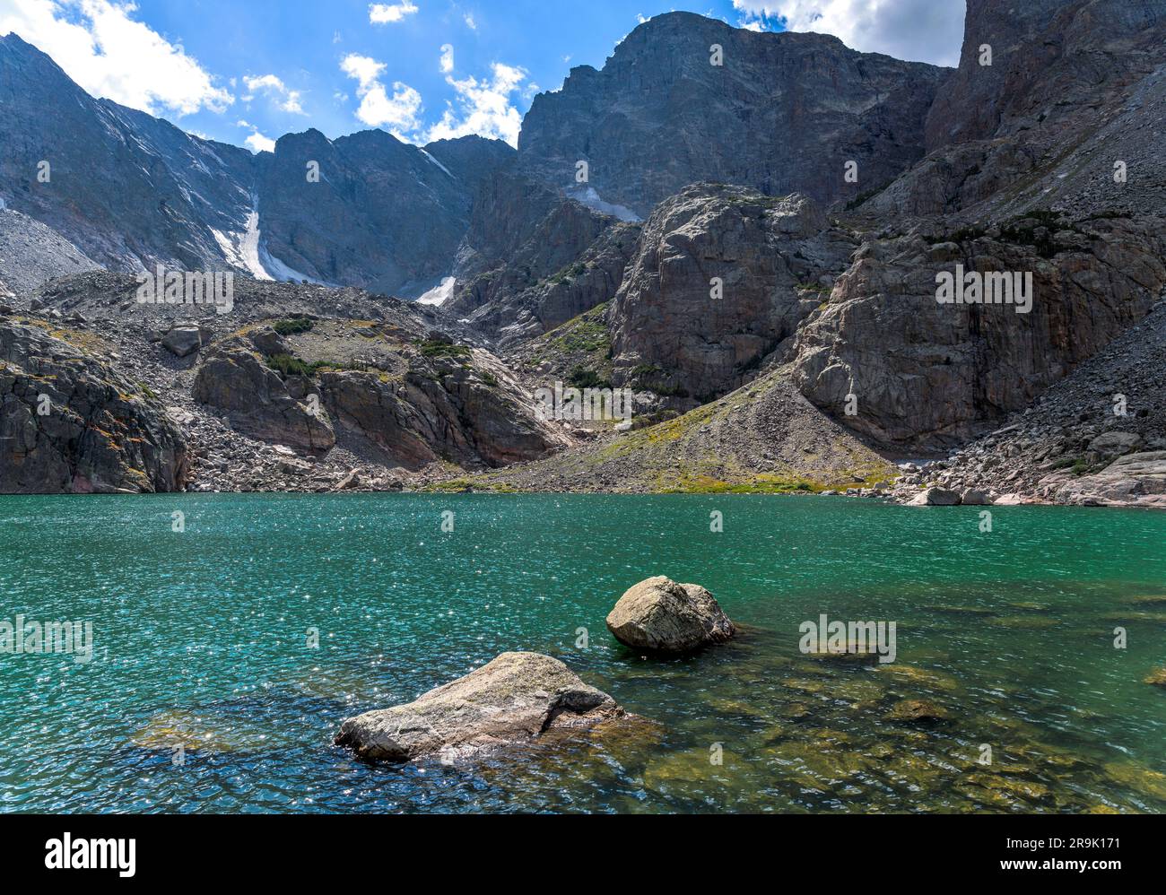 Sky Pond - A closeup view of a colorful alpine lake - Sky Pond at base of Taylor Peak and Taylor Glacier on a sunny Summer day. RMNP, CO, USA. Stock Photo