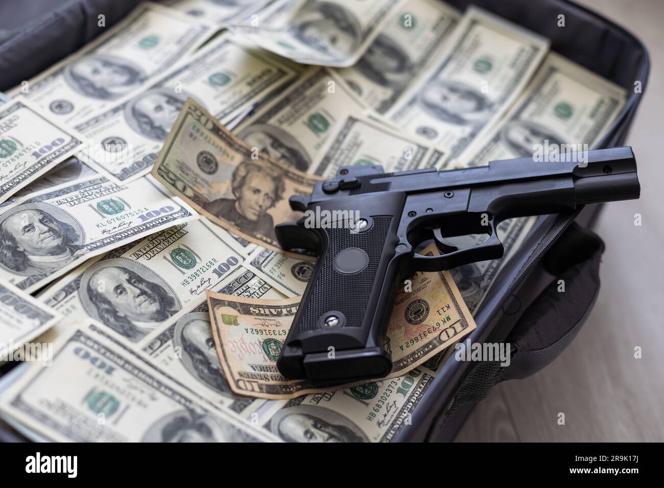 Suitcase with pile of dollars. Opened silver case with money. Better to